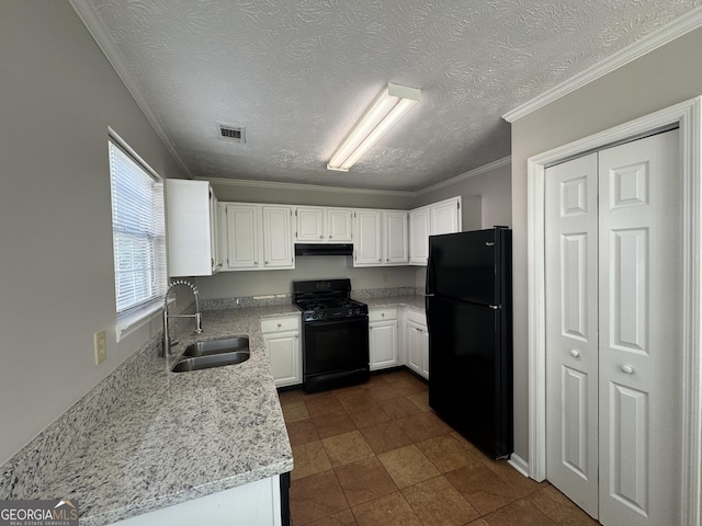 kitchen with a textured ceiling, visible vents, a sink, white cabinets, and black appliances