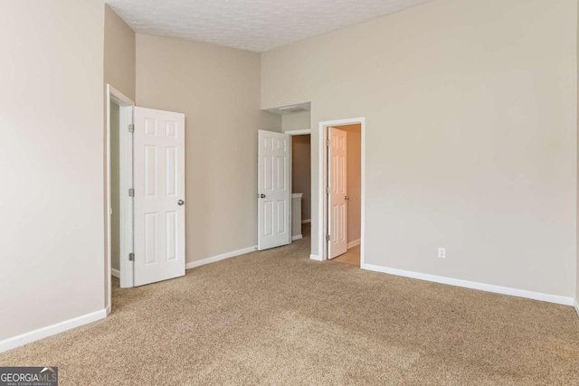 unfurnished bedroom with carpet floors and baseboards