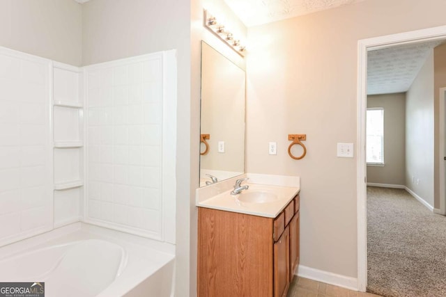 bathroom with baseboards, shower / bathing tub combination, and vanity