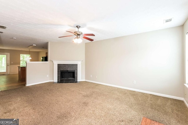 unfurnished living room featuring ceiling fan, baseboards, and carpet