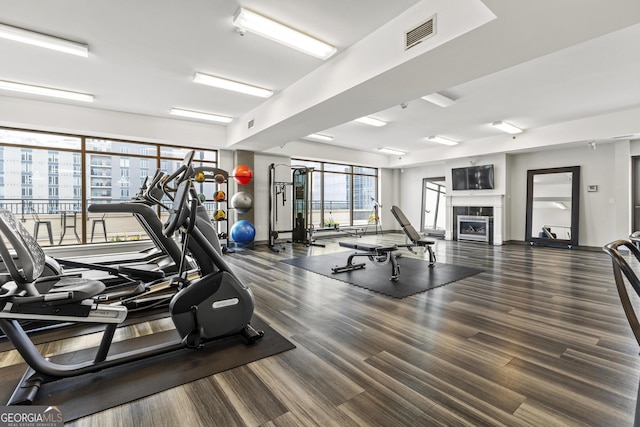 workout area with a fireplace and visible vents