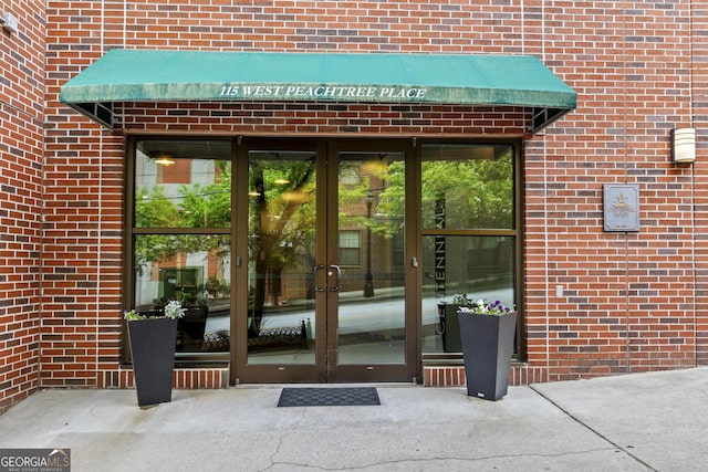 property entrance with french doors and brick siding