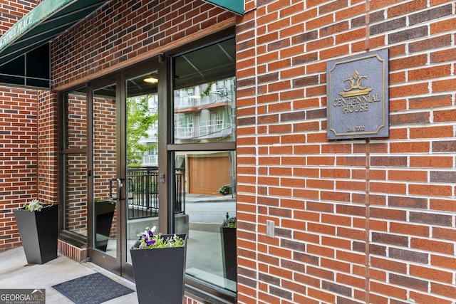 property entrance with brick siding