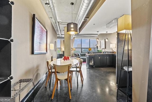 dining space featuring finished concrete floors