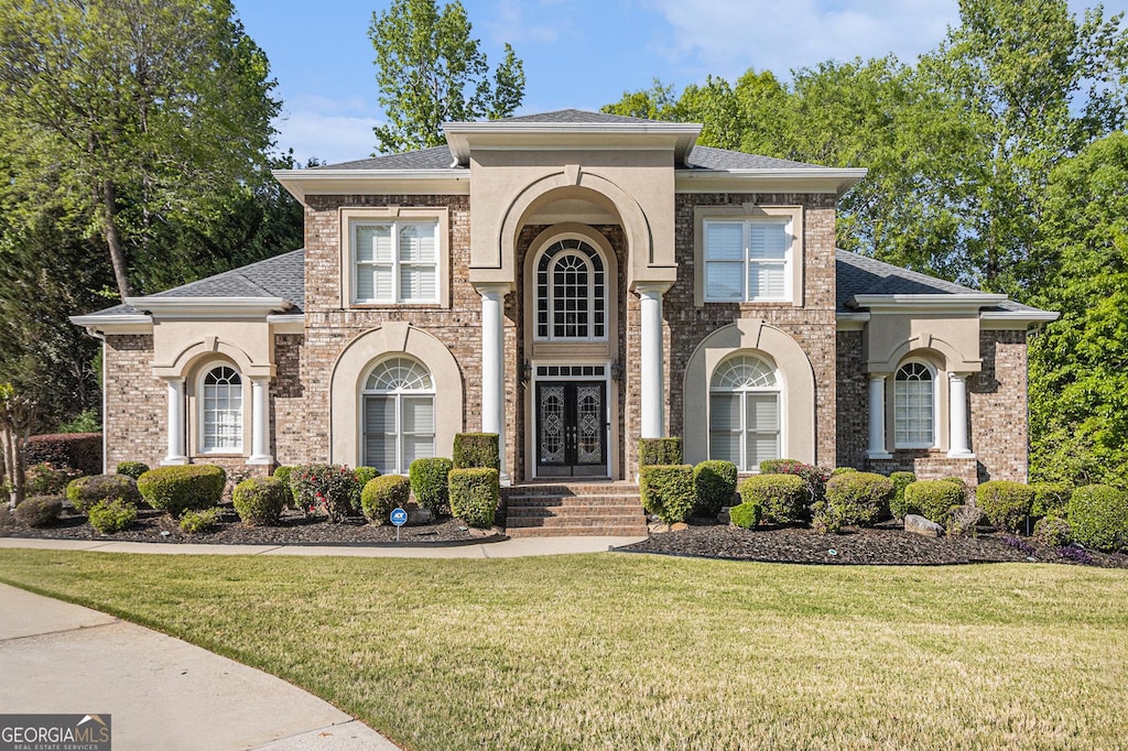 4855 Regency Trce SW, Atlanta, GA 30331 - view of front of house with brick siding, a shingled roof, and a front yard
