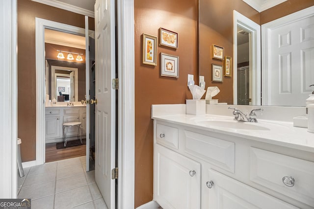 bathroom with tile patterned flooring, ornamental molding, and vanity