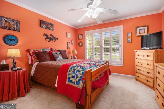 carpeted bedroom featuring crown molding, a ceiling fan, and baseboards