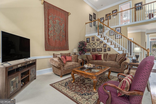 living room with crown molding, a towering ceiling, baseboards, stairway, and carpet flooring