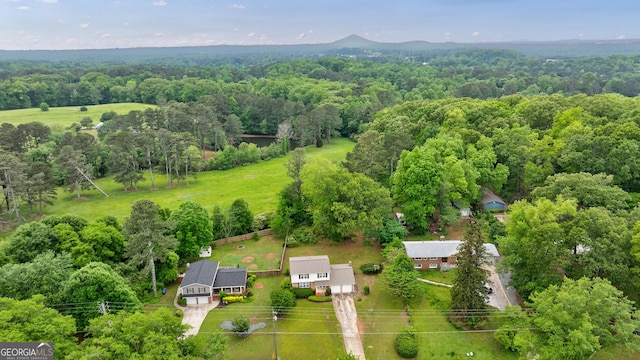 bird's eye view featuring a wooded view
