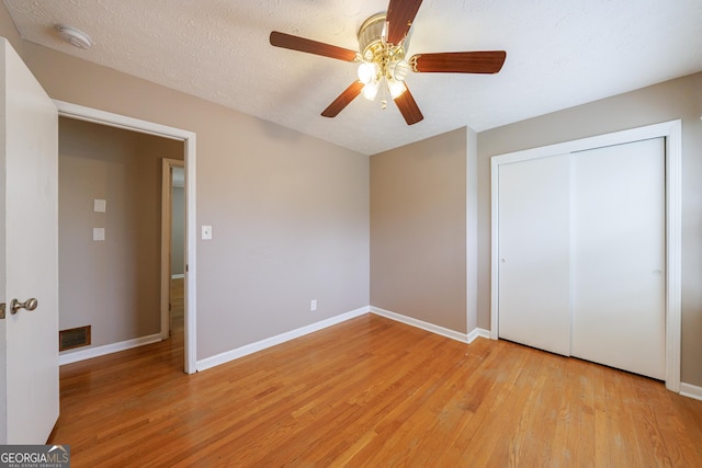 unfurnished bedroom featuring baseboards, light wood-style flooring, and visible vents