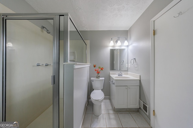 full bathroom featuring tile patterned flooring, vanity, a textured ceiling, visible vents, and a stall shower