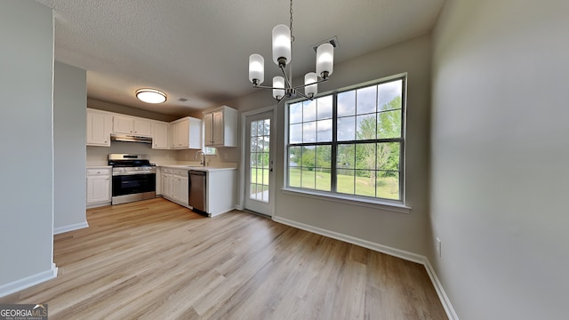 64 Dogwood Rdg, Hampton, GA 30228 - kitchen featuring light countertops, stainless steel range with gas cooktop, baseboards, under cabinet range hood, and dishwashing machine