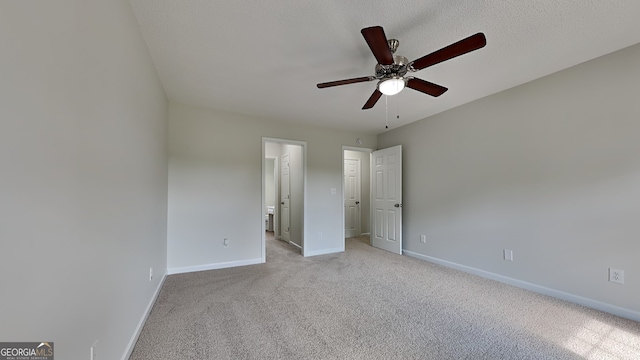 64 Dogwood Rdg, Hampton, GA 30228 - unfurnished bedroom with baseboards, light carpet, a ceiling fan, and connected bathroom