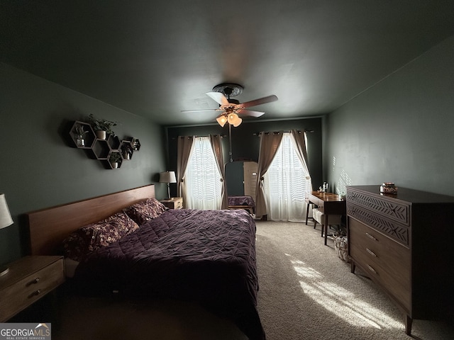 bedroom with ceiling fan and light carpet