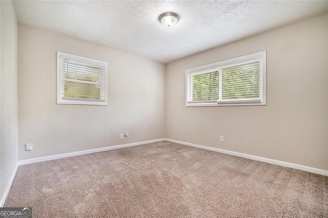 4004 Knightsbridge Rd, Kennesaw, GA 30144 - carpeted empty room featuring baseboards and a textured ceiling