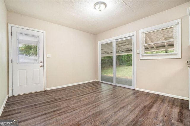 4004 Knightsbridge Rd, Kennesaw, GA 30144 - unfurnished room with baseboards, a textured ceiling, and wood finished floors