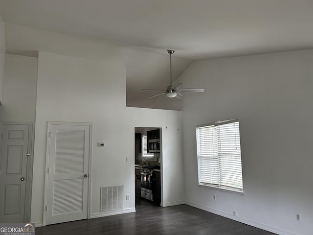 1047 Plantation Way NW, Kennesaw, GA 30144 - unfurnished living room featuring ceiling fan, dark wood-style floors, high vaulted ceiling, and baseboards