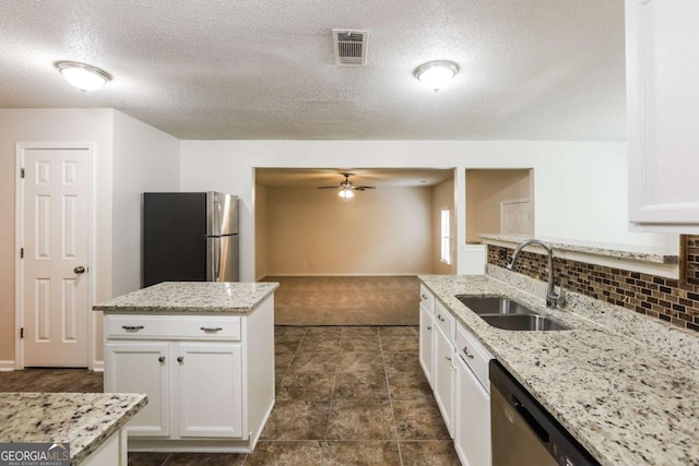 kitchen featuring a ceiling fan, dark carpet, white cabinets, a sink, and appliances with stainless steel finishes