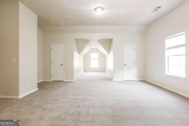 empty room featuring carpet flooring, baseboards, and visible vents