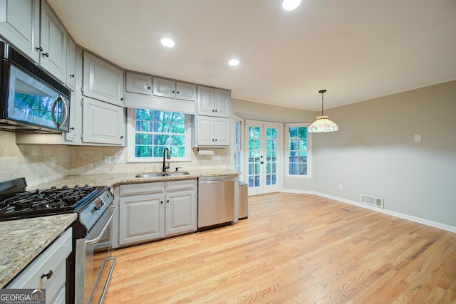 3480 Stillridge Dr, Alpharetta, GA 30022 - kitchen with stainless steel appliances, a sink, decorative backsplash, light wood finished floors, and baseboards