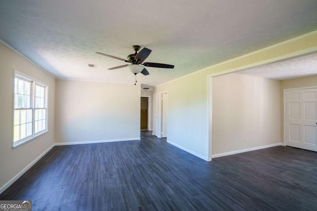 unfurnished room with crown molding, dark wood-style flooring, baseboards, and a textured ceiling