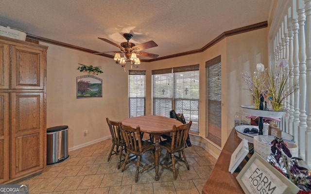 dining space featuring crown molding, baseboards, ceiling fan, a textured ceiling, and light tile patterned floors