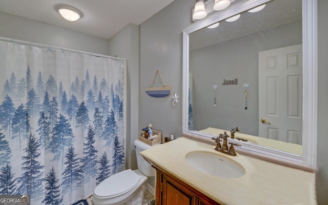 full bath featuring vanity, curtained shower, toilet, and a textured ceiling