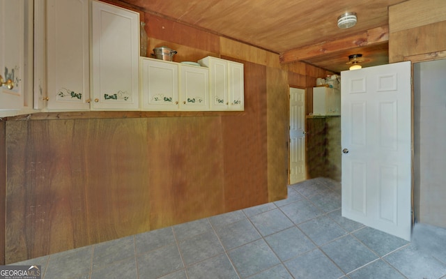 tiled spare room with wooden walls and wood ceiling