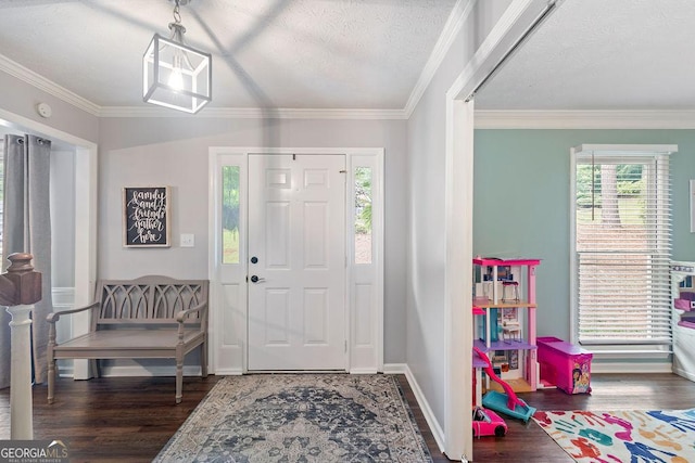 foyer entrance with ornamental molding and wood finished floors