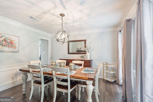 dining space with visible vents, crown molding, a wainscoted wall, and dark wood-style floors
