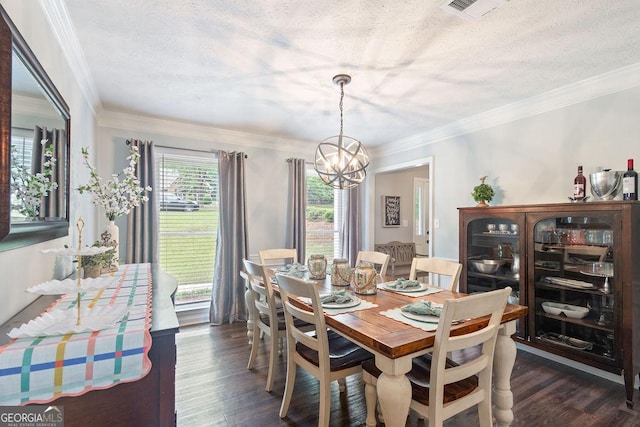 dining room featuring a textured ceiling, a chandelier, ornamental molding, and visible vents