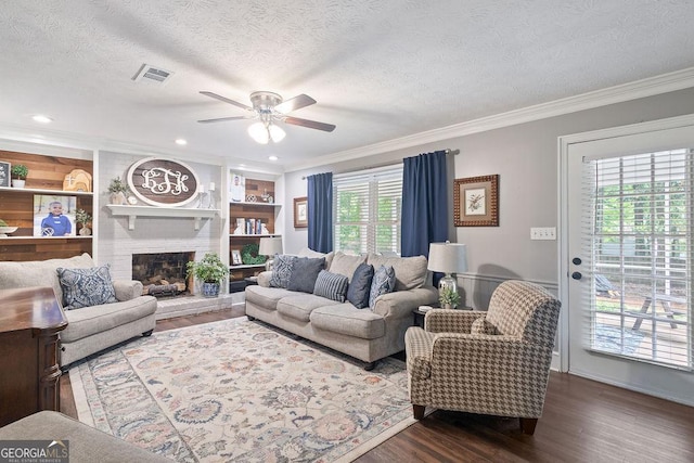 living area featuring a textured ceiling, ceiling fan, dark wood finished floors, and visible vents
