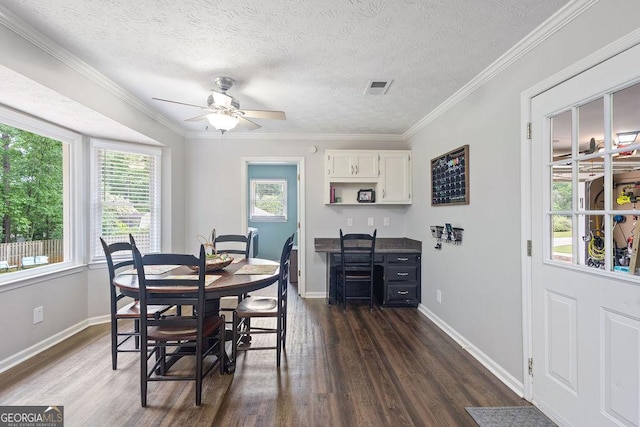 dining room featuring visible vents, a ceiling fan, baseboards, and dark wood-type flooring
