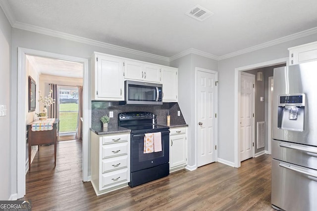 kitchen featuring white cabinets, stainless steel appliances, visible vents, and dark wood-type flooring