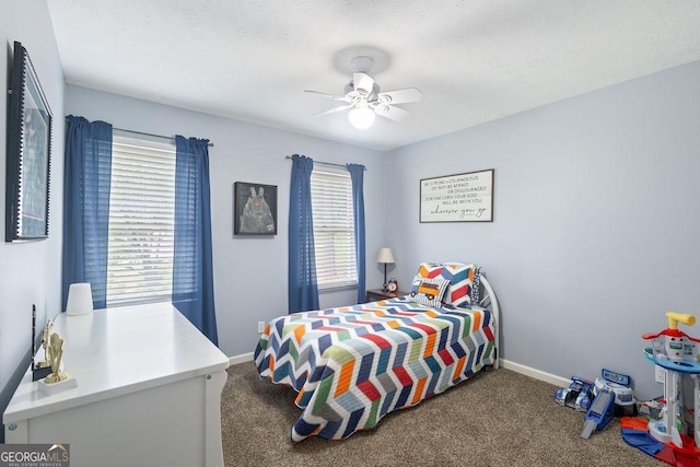 carpeted bedroom with baseboards and a ceiling fan