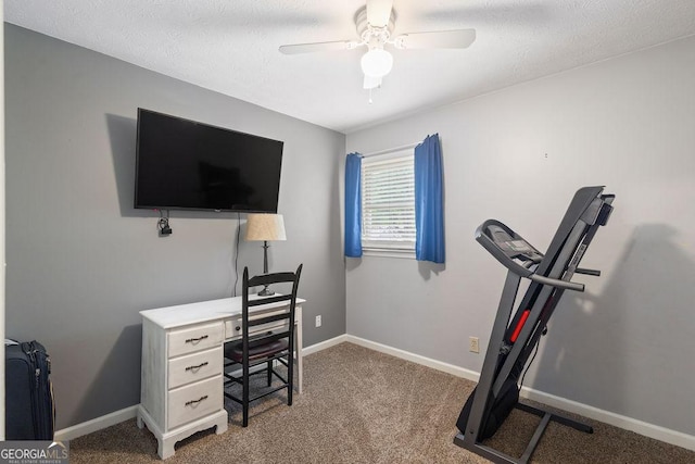 home office with baseboards, a textured ceiling, carpet, and ceiling fan