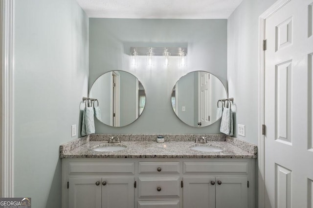 full bathroom featuring a sink and double vanity