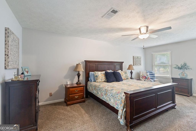 bedroom featuring light colored carpet, a textured ceiling, ceiling fan, and visible vents