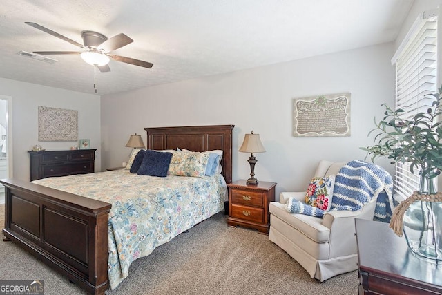 bedroom featuring ceiling fan, light carpet, and visible vents