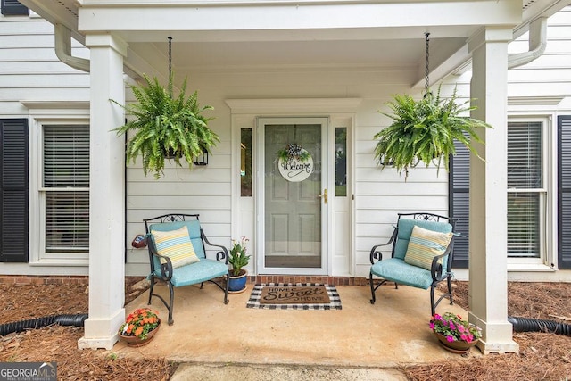 view of exterior entry featuring covered porch