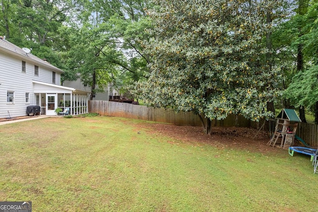 view of yard with a fenced backyard and a sunroom