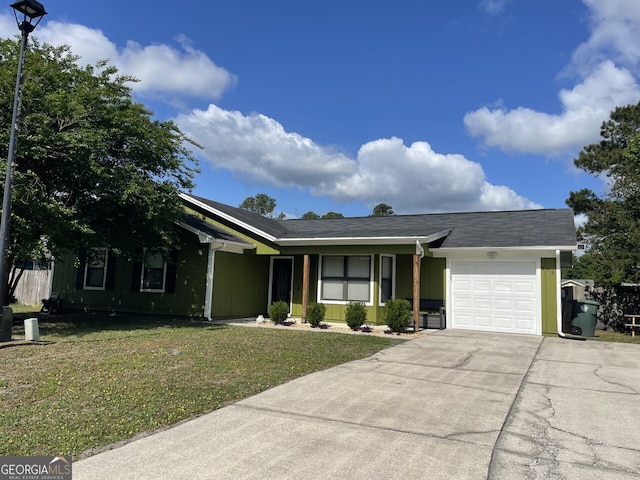 ranch-style home featuring driveway, a front lawn, and a garage
