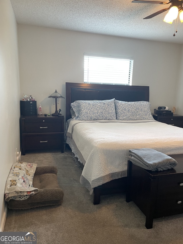 bedroom with carpet flooring, a textured ceiling, and ceiling fan