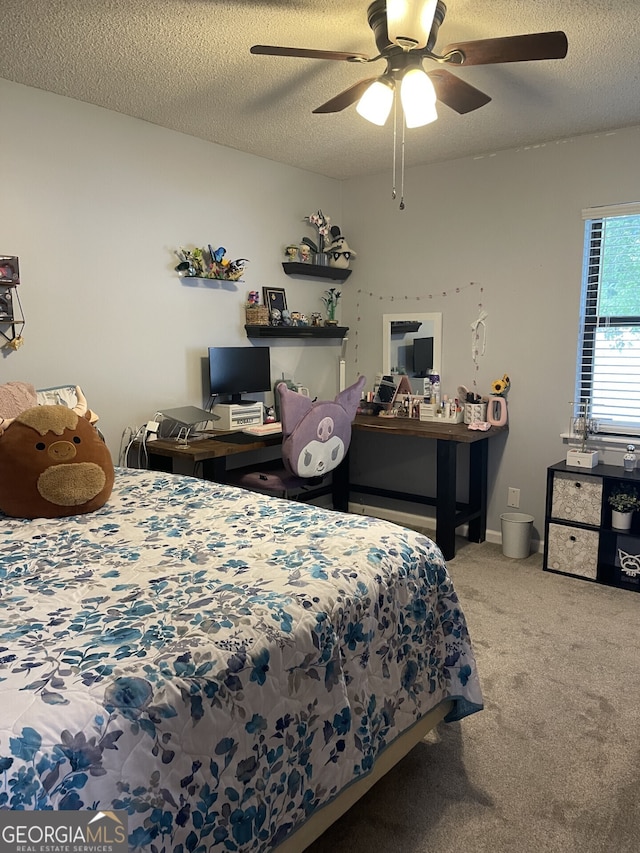 bedroom with carpet flooring, a ceiling fan, and a textured ceiling