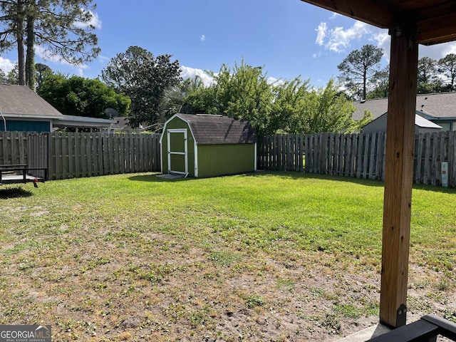 view of yard with a storage shed, an outdoor structure, and a fenced backyard
