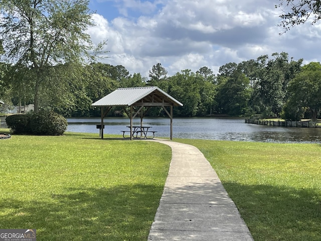 view of home's community featuring a yard, a water view, and a gazebo