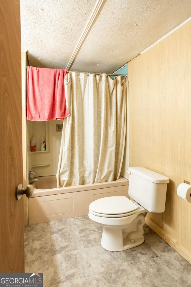 full bathroom with toilet, a textured ceiling, and shower / tub combo with curtain