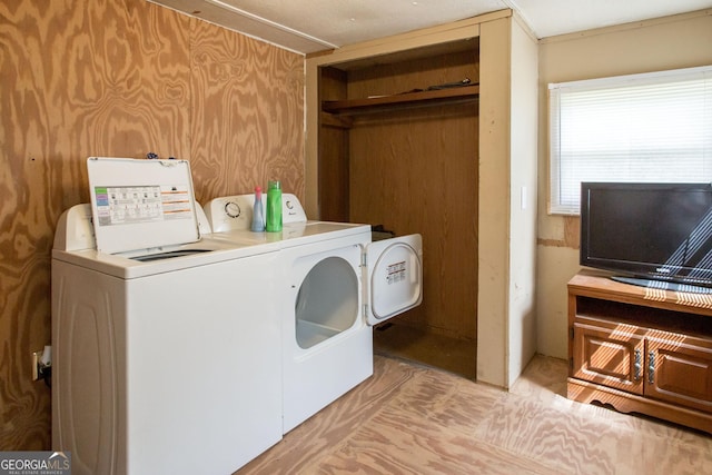 washroom with separate washer and dryer and laundry area