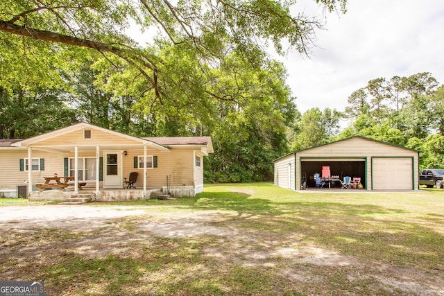 exterior space featuring a garage, an outdoor structure, and a porch