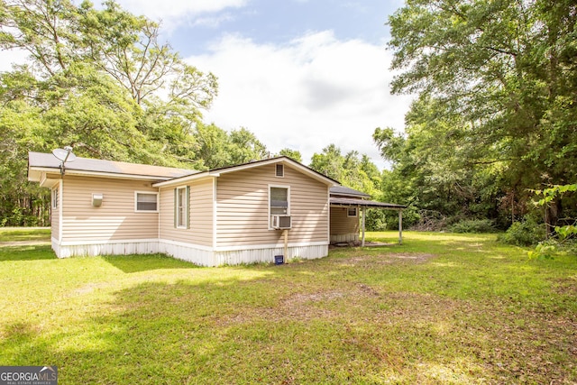 back of property featuring a lawn, a carport, and cooling unit